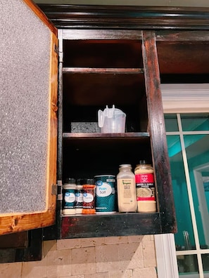A wooden cabinet with shelves containing various kitchen items like salt, pepper, and spices. - Pet friendly/2bedroom//Great Location/Very clean house in Central Okc (Oklahoma City)