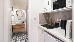 A compact kitchen with a microwave, sink, and coffee machine. - South & Comfort (Dubrovnik)