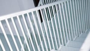 A staircase with white railings and white steps. - Vista Homes Villa (Kigali)