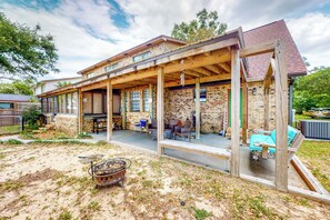 A two-story house with a covered patio area, a brick exterior, and a wooden deck. - Dock! Bayfront Pensacola Retreat 10 Mi to Dtwn (Pensacola)