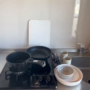 A kitchen with a stove, pots, a kettle, and a sink. - Dc Sakura-Garden (Osaka)