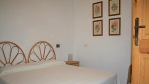 A bedroom with a bed, a nightstand, and a door. - Holiday Residence La Cota Quinta, Rio Nell"elba (Rio)