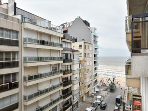 A multi-story building with balconies, a street in front, and a view of the sea. - Sunny Escape at Albert Beach (Knokke-Heist)