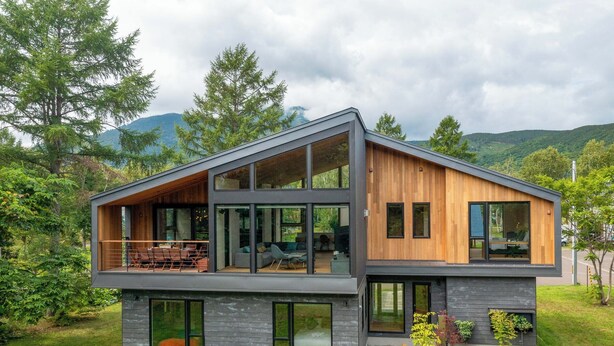 A modern two-story house with large windows, a balcony, and a wooden exterior. - Shion (Kutchan)