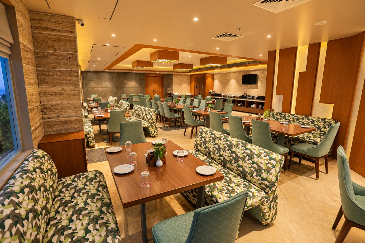 A restaurant with multiple dining areas, including booths and tables, with a modern design and a large window on one side.