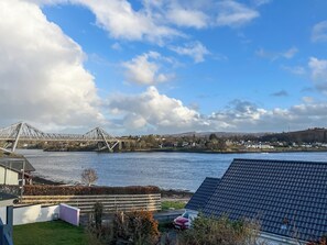 A view of a river with a bridge, houses, and a solar panel roof. - 4 bedroom accommodation in North Connel (North Connel)