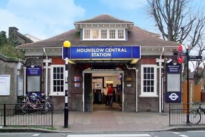 Hounslow Central Station with a clear entrance, a signboard, and a bicycle parked outside. - Exclusive Studio in the Heart of Hounslow! (Greater London)