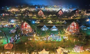 A campsite with multiple tents and cabins, some with attached porches. - LEAF VILLAGE & FARM LÀNG LÁ (Da Nang)