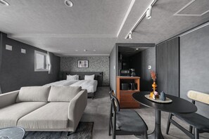 A modern hotel room with a sofa, a bed, a dining table, and a kitchenette. - GRAN HILLS 405 / Chitose City Hokkaidō (Chitose City)