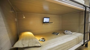 A bunk bed with a laptop on the upper bunk, a pillow, and a folded towel on the lower bunk. - Mongolian Vision Tours (Ulaanbaatar)