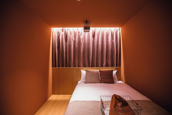 A hotel room with a bed, a headboard, a bedside table, and a wall-mounted light fixture. - SABLIER by R HOTEL (Osaka)