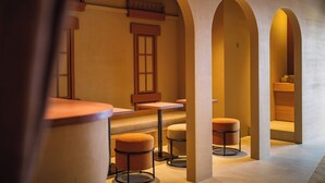 A hotel lobby with arched ceilings, wooden furniture, and a central seating area. - SABLIER by R HOTEL (Osaka)