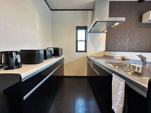 A modern kitchen with a stainless steel sink, a microwave, a kettle, and a toaster on the countertop. - 72 Mtview Building B  12minute walk from Kawagu / Minamitsuru District Yamanashi (Minamitsuru District)