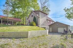 A large building with a covered porch, a garage, and a gravel driveway. - Getaway 1 Mi to Sligo Marina & Center Hill Lake! (Smithville)