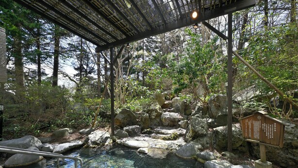 A natural hot spring area with clear water, rocks, and a wooden structure. - Livemax Resort Shikabe (Shikabe)