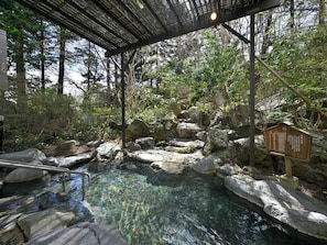 A natural hot spring area with clear water, rocks, and a wooden structure. - Livemax Resort Shikabe (Shikabe)