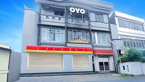 A building with a prominent 'OYO' sign, large windows, and a modern architectural style. - Cozy Twin Escape in Indonesia with Free WiFi (Bandar Lampung)