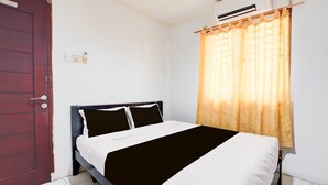 A room with a bed, a door, an air conditioning unit, and a window with curtains. - Luxury Deluxe DBL Retreat W/ Free WiFi and Parking (Batam)