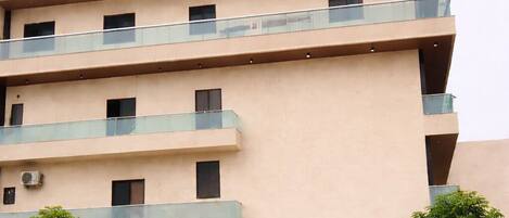 A multi-story building with balconies and a sign reading 'HOTEL SHREE JI PALACE'.