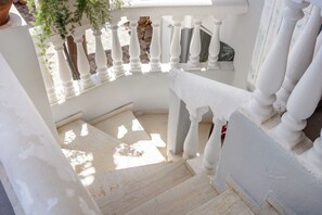 A staircase with white balustrades leading to a landing. - malia boutique studios (Malia)