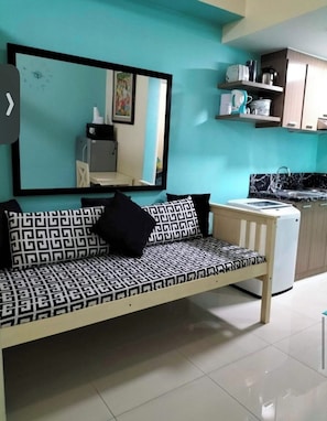 A kitchenette with a sink, a microwave, and a refrigerator. - Charming Condo With Private Pool in Las Piñas, Philippines (Las Pinas)