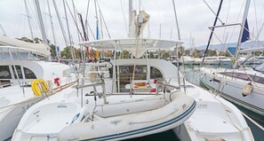 A marina with multiple sailboats docked, featuring a cabin with a deck area, a lifebuoy, and a catamaran named 'Kataki.' - Sun-Kissed Sailing Adventure in Islas Sarónicas (Alimos)