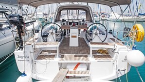 A boat deck with a steering wheel, winches, and a covered area. - Sun-Kissed Sailing Adventure in the Ionian Islands, Lefkada (Lefkada)