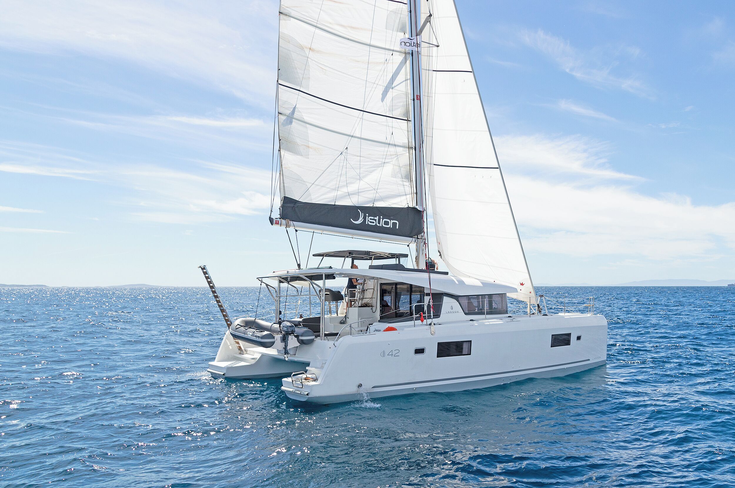 A sailboat with a cabin and a mast, sailing on the water.
