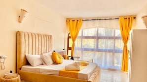Ein Schlafzimmer mit Bett, Heizkörper, Nachttisch und einem Fenster mit Vorhängen.