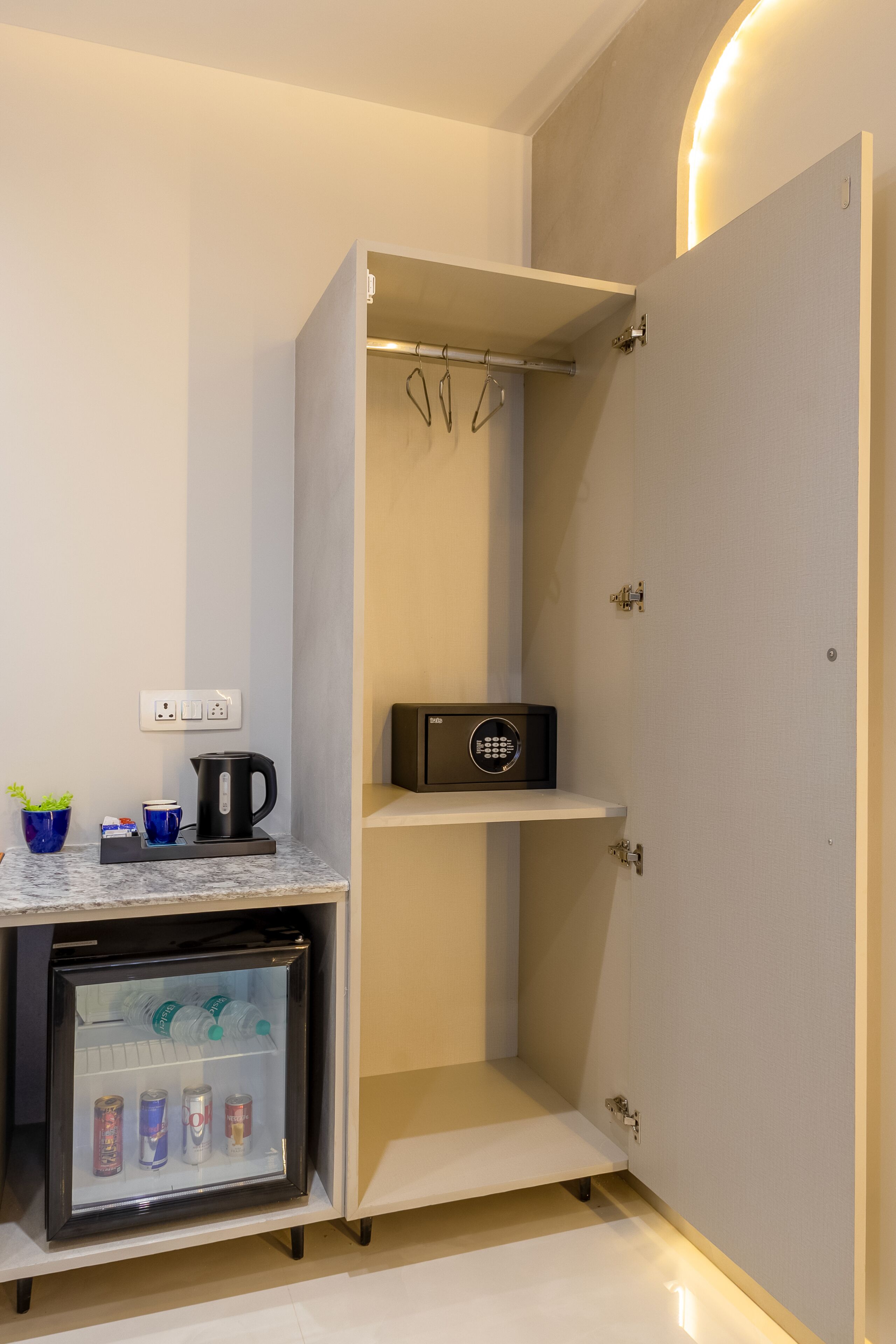 A compact kitchenette with a refrigerator, a coffee maker, and a microwave.