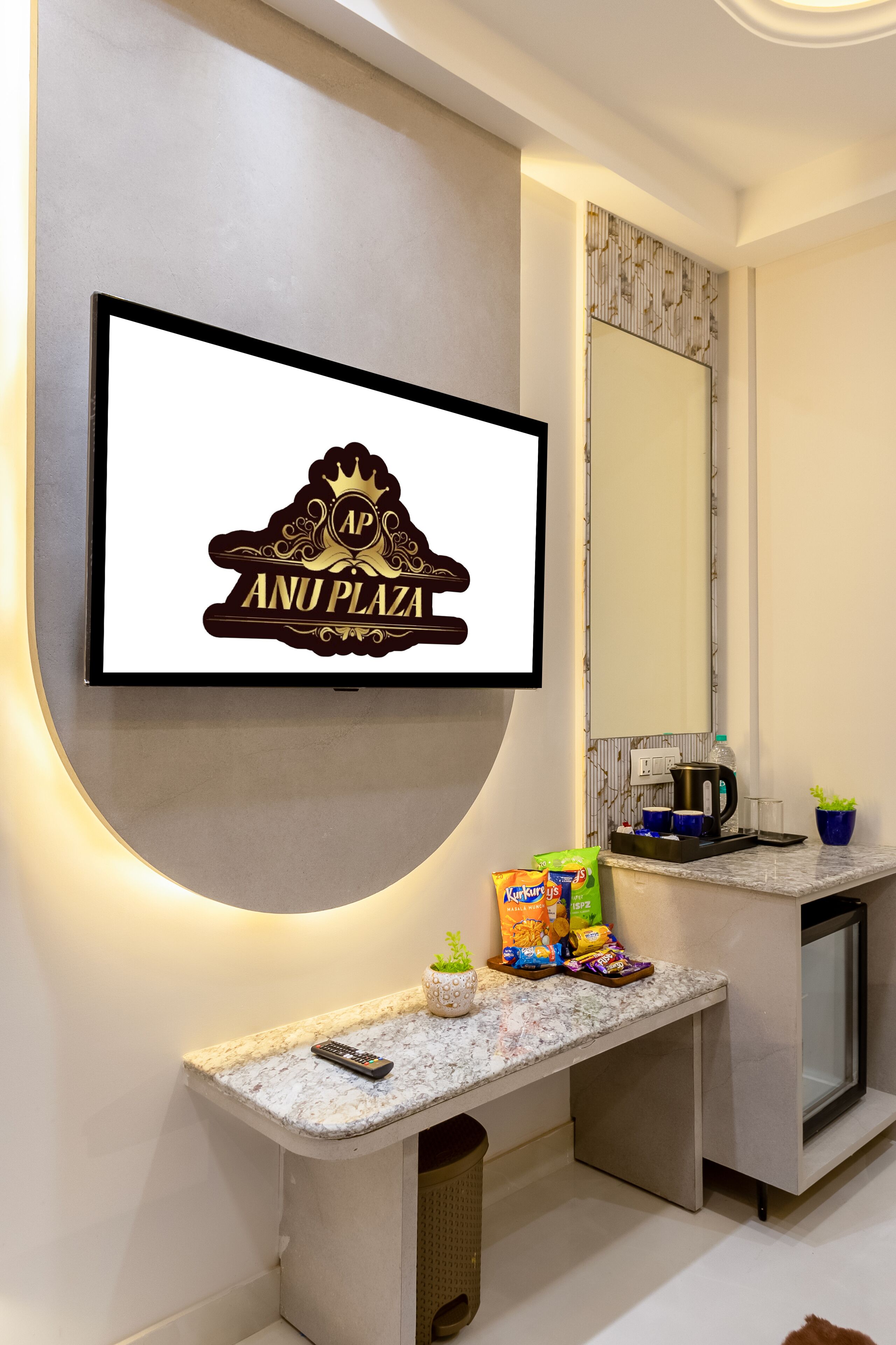 A modern bathroom with a framed sign, a countertop with snacks, a kettle, and a mirror.