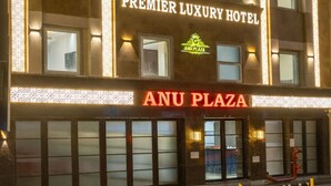 A hotel building with multiple floors, large windows, and a prominent sign reading 'ANU PLAZA HOTEL.' - Anu Plaza-5Mins from Connaught Place (New Delhi)