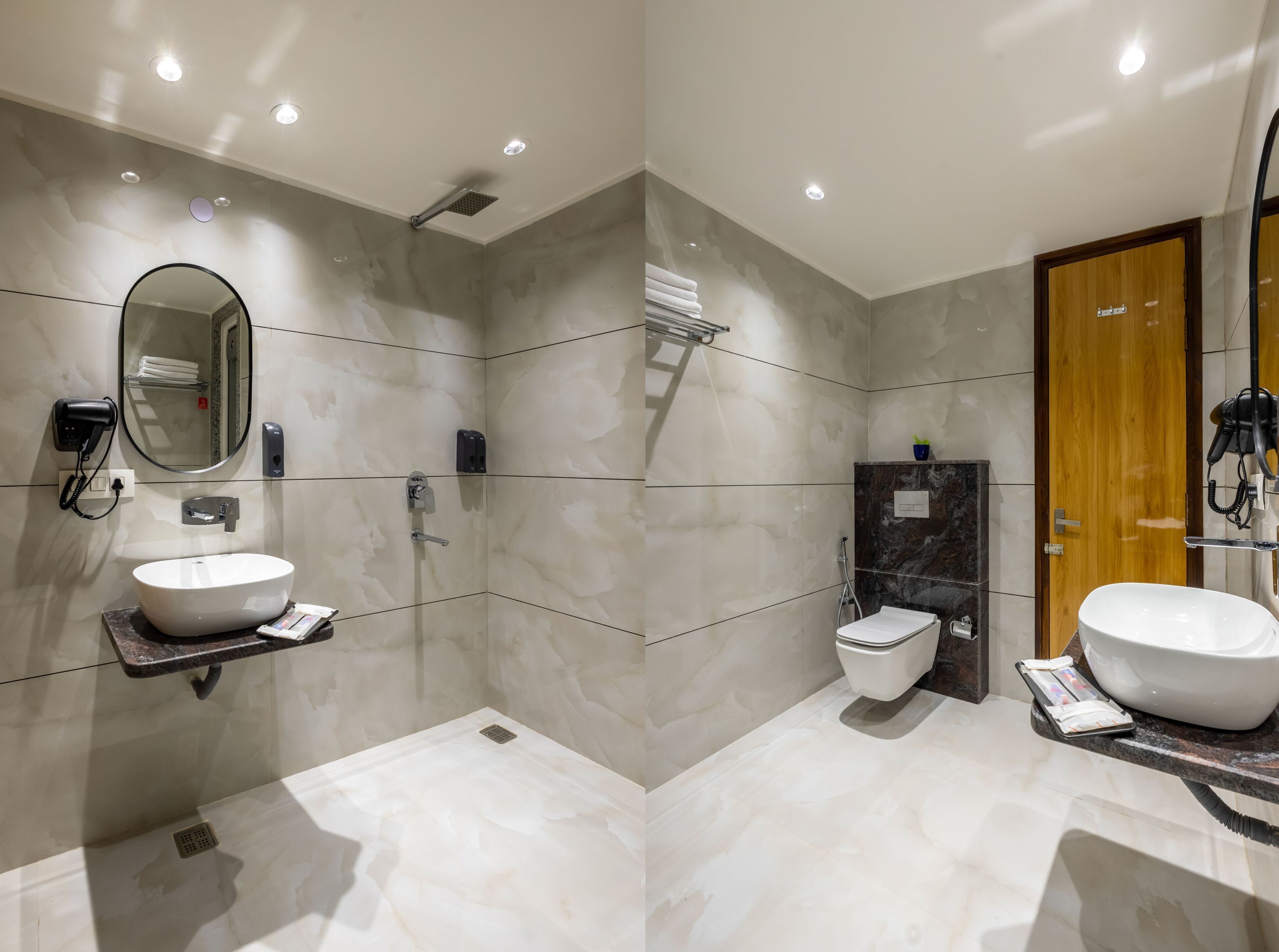 A modern bathroom with a large mirror, a sink, a toilet, and a shower area.