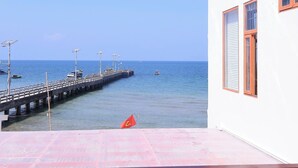 A pier extending into the sea with a building on the right side. - Prospera - Hòn Sơn Beachfront Hotel  (Kien Hai)