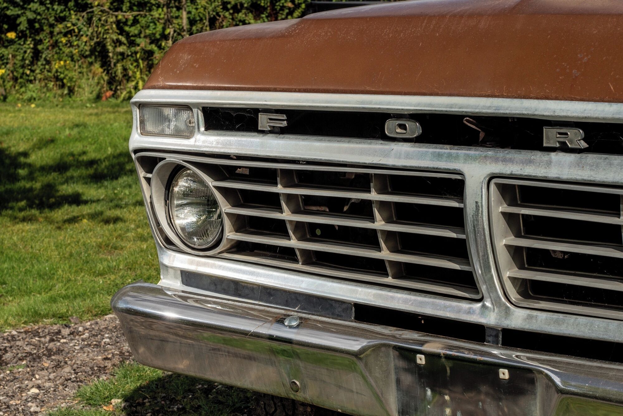 A close-up of a vehicle's front grille with the brand name 'FORD' visible.