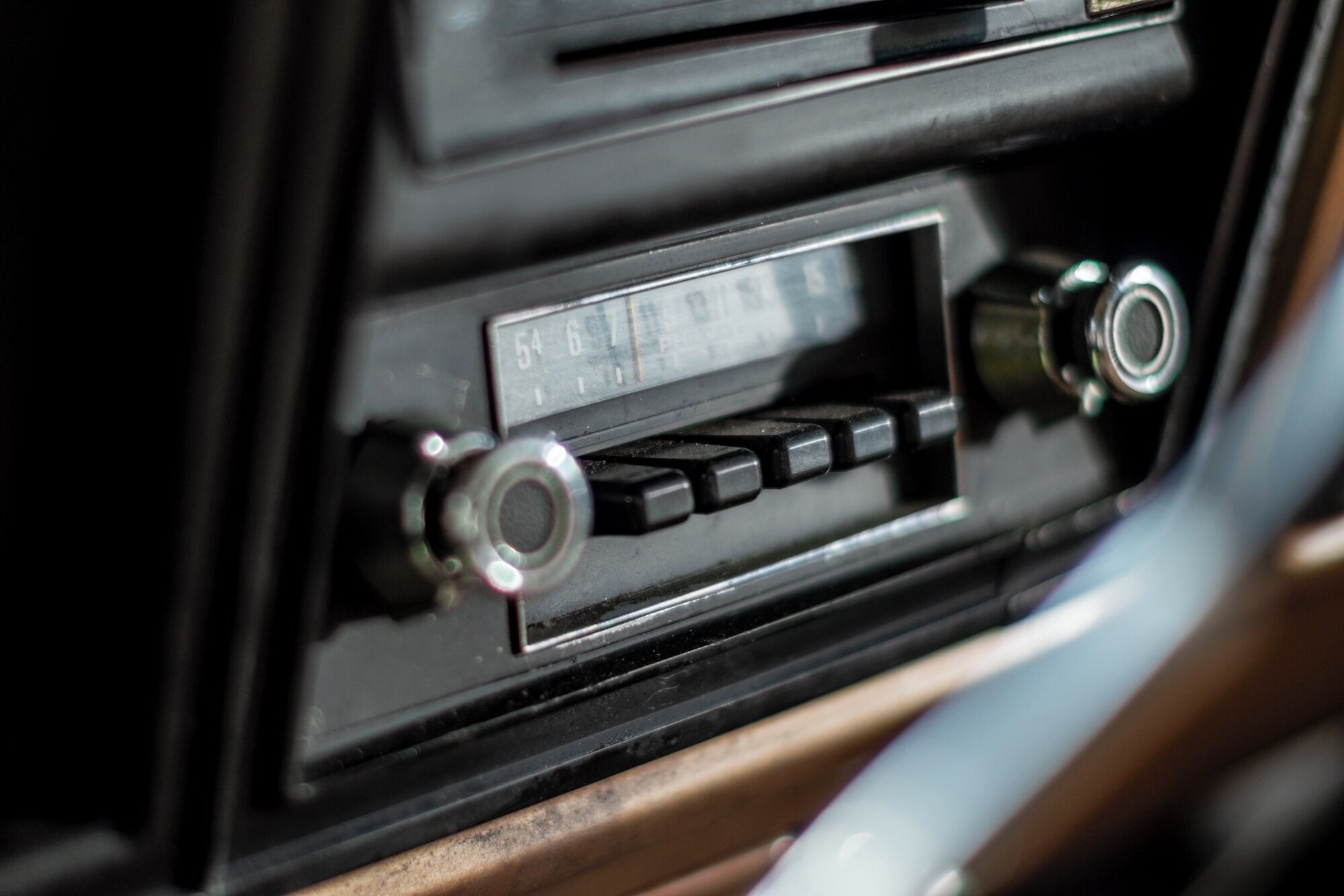 A car's dashboard with a radio, a cassette player, and a CD player.