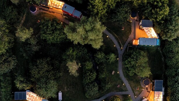 An aerial view of a residential area with multiple houses connected by pathways, surrounded by dense trees. - 1 Bed Vehicle Luxury Camper -hot Tub, Pets - Willy (Skegness)