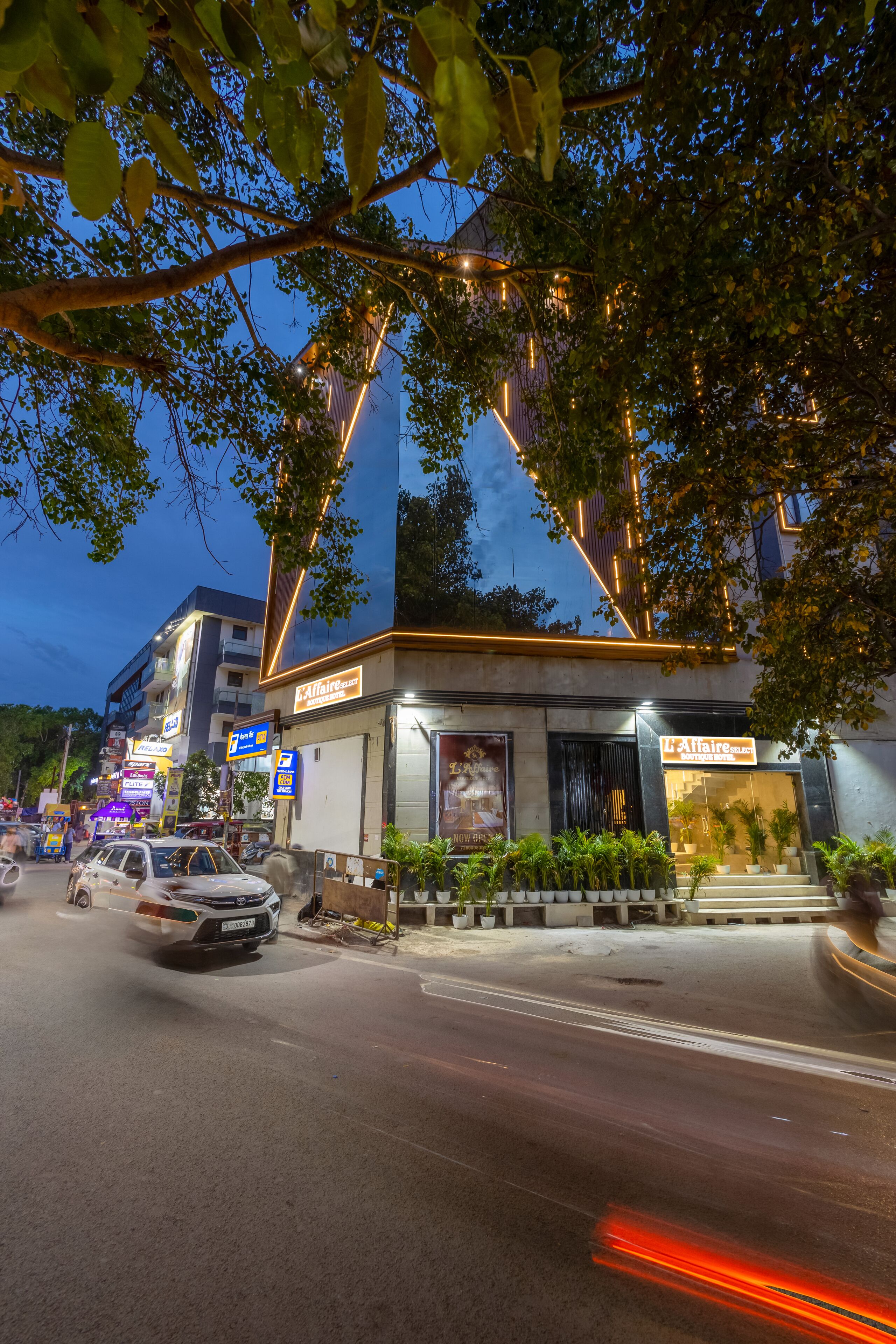 A building with a modern design, featuring a prominent entrance and signage for a hotel.