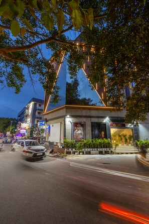 A building with a modern design, featuring a prominent triangular structure and a well-lit entrance. - Hotel Laffaire Select Near Rajori Metro (New Delhi)