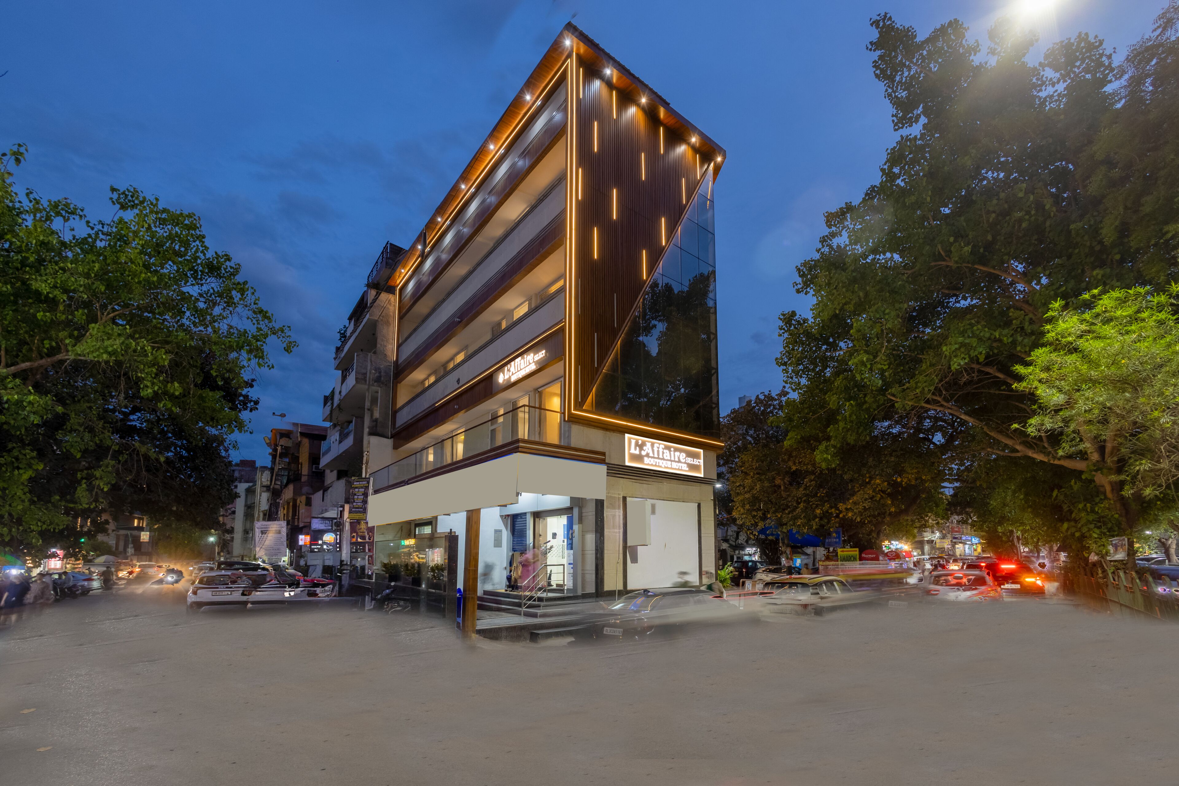 A modern building with a glass facade, a visible entrance, and a sign indicating a business establishment.