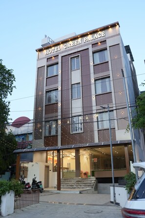 A multi-story hotel named 'Hotel Green Palace' with a modern facade, large windows, and a visible entrance with steps leading up to the door. - Hotel Green Palace (Prayagraj)