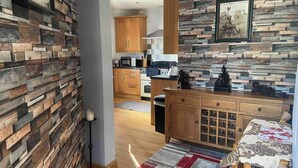 A modern kitchen with wooden cabinets, a microwave, and a stove. - 1 Apartment Sleeps 2 (Sutton-in-Ashfield)
