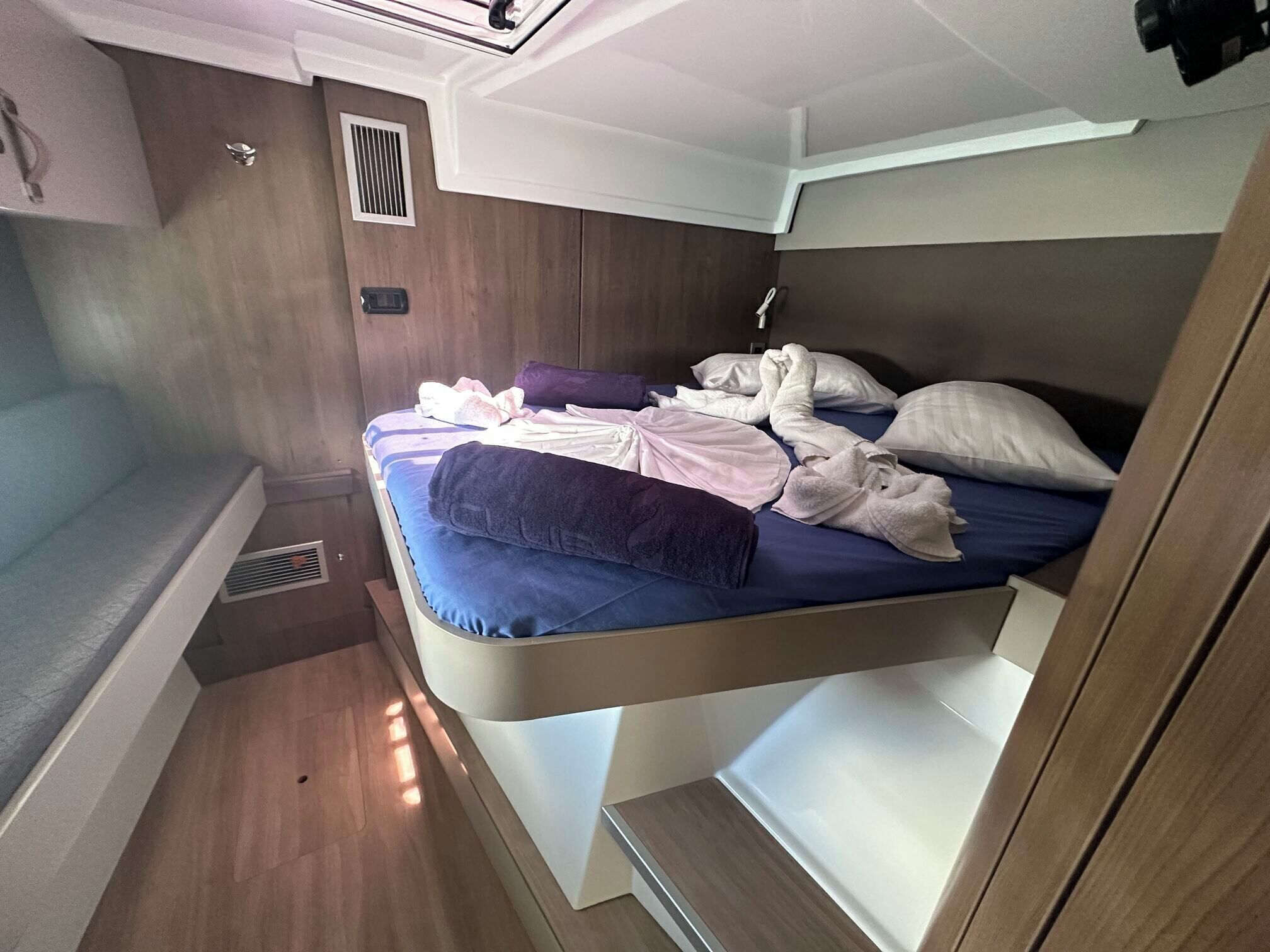 A compact, well-lit cabin with a bunk bed, a small window, and a built-in sink.