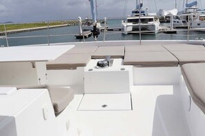 A boat deck with seating areas and a control panel. - Caribbean Dream: Sun-soaked Sailing Adventure from Tortola, Islas Vírgenes Británicas (Road Town)