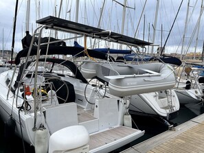 A marina with multiple sailboats docked.