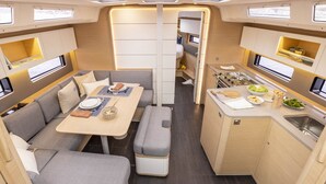A compact RV interior with a dining area, kitchenette, and seating.