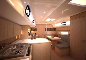 A compact kitchen with a stove, sink, and a small dining area with a bench.