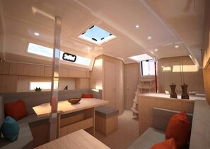 A modern interior with a dining area, seating, and a skylight. - Sun-Kissed Sailing Adventure in Antiguo Puerto de La Rochelle (La Rochelle)