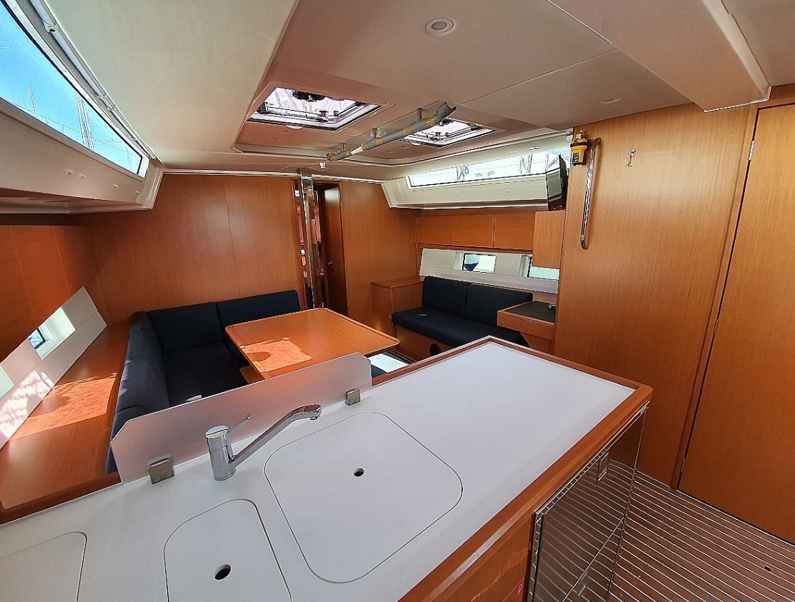 A compact interior with a kitchenette, a dining area, and a seating space.
