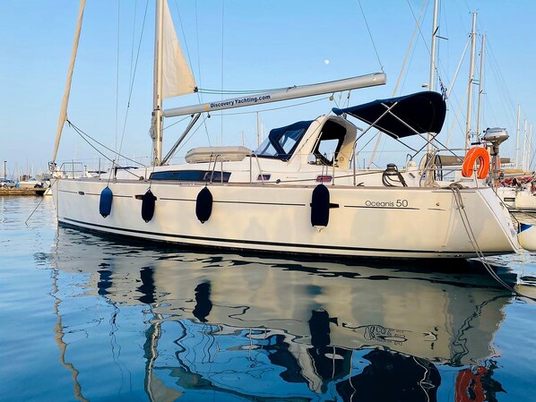 A yacht named 'Oceanis 50' docked at a marina with calm waters reflecting the boat. - Sun-Kissed Sailing Adventure in the Sporades Islands from Volos, Thessaly (Volos)